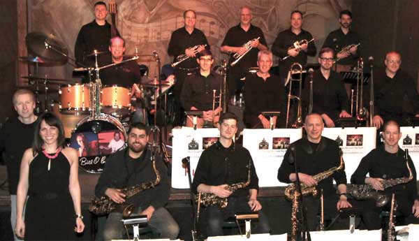 The photo of the band The Flat Cats, holding instruments and looking at the camera, smiling