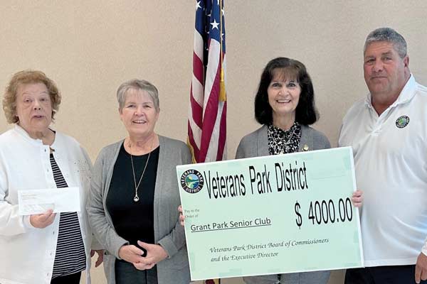 Director Bill Otte resents a check for $4000 to Grant Park Senior Club members.