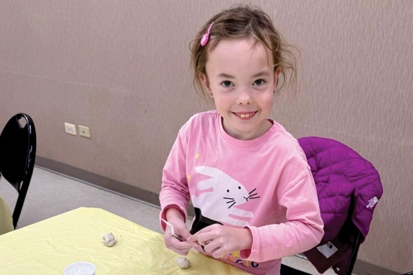 A girl showing her artwork